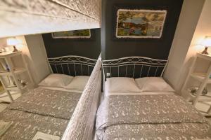 two beds in a room with two bedsitures at #Tyrtaiou Modern Design Studio in Mytilene