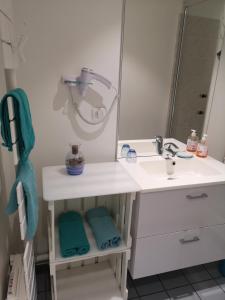 een badkamer met een wastafel en een spiegel bij Au Terminus 6 Personnes in Hautvillers