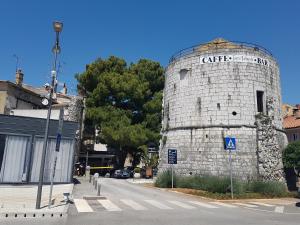 an old stone building on the side of a street at Poreč old town, apartments in Poreč +6 photos
