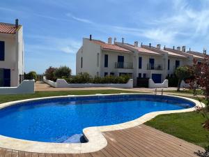 a swimming pool in front of a house at Les Dunes 5081 in Torroella de Montgrí