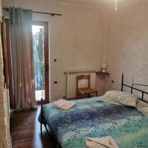 a bedroom with a bed and a chair and a window at B&B Feral in Rovinj