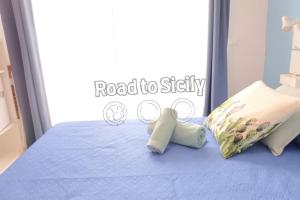 two stuffed animals sitting on top of a bed at Mizar - Road to Sicily in Marina di Ragusa