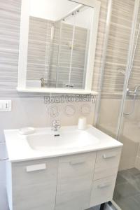 a bathroom with a white sink and a shower at Mizar - Road to Sicily in Marina di Ragusa