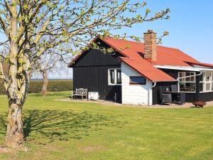 a black and white barn with a red roof at Holiday home Vinderup XXV in Vinderup