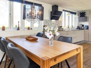 a wooden table in a kitchen with a dining room at Holiday home Vinderup XXV in Vinderup