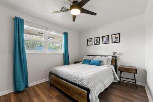 a bedroom with a bed and a ceiling fan at A Pirates Dream in Long Beach