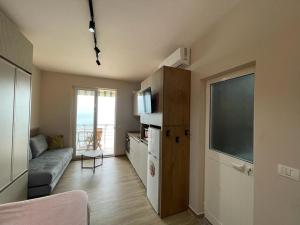 a small living room with a couch and a television at Bellavista apartment in Durrës