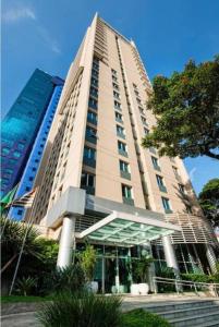 a large tall building with a building at Flat BOUTIQUE em frente ao metrô MOEMA in Sao Paulo