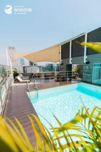 a swimming pool on the roof of a building at Ramada Encore by Wyndham Lima San Isidro in Lima