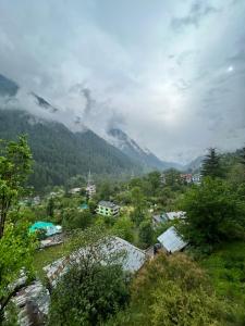 a view of a village with a mountain in the background at Malang Kasol in Kasol
