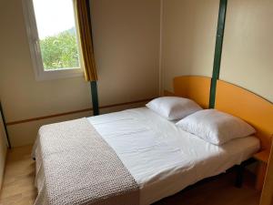 a bedroom with a bed with two pillows on it at La vallée in Belvédère