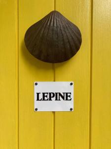 a sign on a yellow door with a mushroom and a legume at Lepine- Holiday apartment in sunny Folkestone in Kent