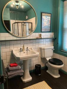 a bathroom with a sink and a toilet and a mirror at Lepine- Holiday apartment in sunny Folkestone in Kent