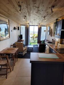 a kitchen and living room with a table and chairs at The Old Boat House in Carlingford