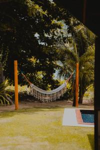 a hammock hanging from a tree in a park at Pousada Rangai in Maragogi