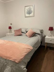 a bed with two pillows on it in a bedroom at Departamento en Condominio Parque Francia in Osorno