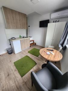 a living room with a table and a kitchen at Admiral1 in Valjevo