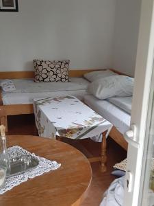 a room with two twin beds and a table at Ranch Farm Stay in Rakovica