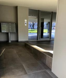 an empty lobby with glass doors in a building at Casa Rita in Brescia