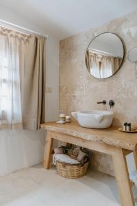 a bathroom with a sink and a mirror at Çiy Restaurant & Konukevi in Kuşadası