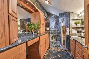 a bathroom with a sink and a shower at Huvila Haven Lake Front Home with Dock and Hot Tub in Newman Lake +38 photos
