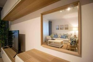 a living room with a white couch and a table at Modern 3br Apt w/ Lg Terrace, Bbq, Ac & Parking in Tavira