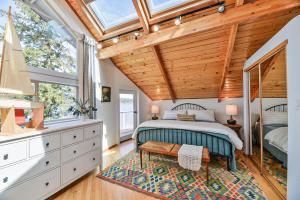 a bedroom with a bed and a wooden ceiling at Huvila Haven Lake Front Home with Dock and Hot Tub 