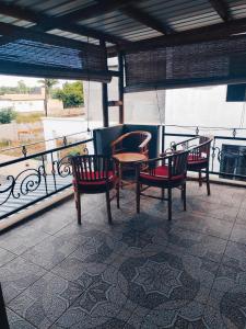 a patio with chairs and a table on a balcony at Privacy House in Triolet