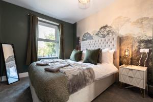 a bedroom with a large bed and a window at Opulent Dorset Gem with Hot-Tub - Parking - Pets in Weymouth