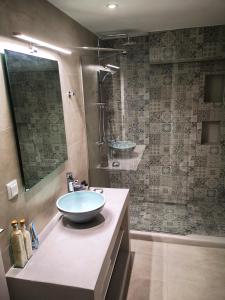 a bathroom with a sink and a shower at EmMi Houses in Nafplio