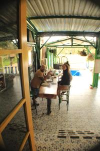 een groep mensen aan een tafel in een restaurant bij Alegria Hostel Boutique in Guatapé