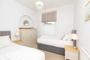 a bedroom with two beds and a window at Pier Top - Free all Island parking permit in Ventnor