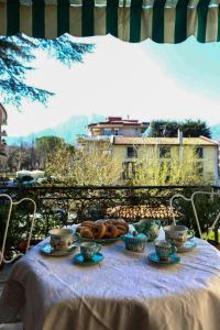a table with tea cups and pastries on it at La Vie En Rose in Cava deʼ Tirreni