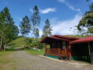 a small house with a dirt road next to it at Finca Tres Equis - Farm and Forest in Tres Equis