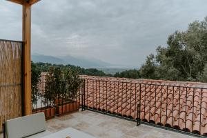 a balcony with a view of a mountain at Çiy Restaurant & Konukevi in Kusadası
