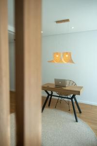 a table with a laptop on it in a room at Olive Boutique Guesthouse in Vila Franca do Campo