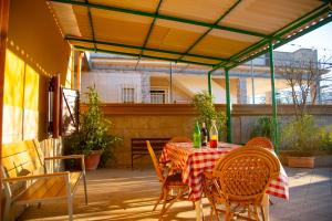 a patio with a table and chairs on a patio at Villa Carrieri in Marina di Lizzano