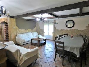 a living room with a table and a couch at Villa La Ballena de Sonabia in Oriñón