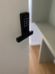 a black remote control sticking out of a door at Olive Boutique Guesthouse in Vila Franca do Campo