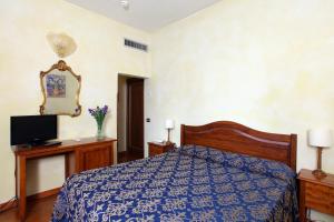 Postel nebo postele na pokoji v ubytování Hotel Bologna