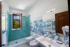 a bathroom with a sink and a toilet and a window at I colori della Luna in Agerola +42 photos