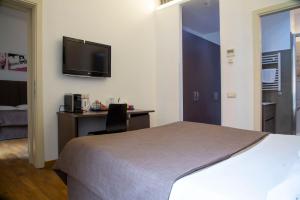 Postel nebo postele na pokoji v ubytování Rome Armony Suites