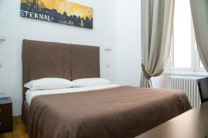 Postel nebo postele na pokoji v ubytování Rome Armony Suites