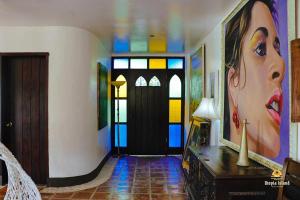 a hallway with a painting of a woman on the wall at Utopia Island Resort in Batangas City