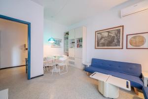 uma sala de estar com um sofá azul e uma mesa em INTO THE BLUE Lavagna Seaside Flat em Lavagna