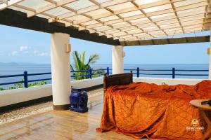 a bed in a room with a view of the ocean at Utopia Island Resort in Batangas City