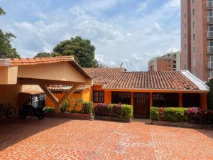 an orange house with a tile roof and a building at Posada El Remanso de Pueblo Nuevo in San Cristóbal