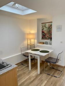 eine Küche mit einem weißen Tisch und 2 Stühlen in der Unterkunft Köln City Apartments in Köln