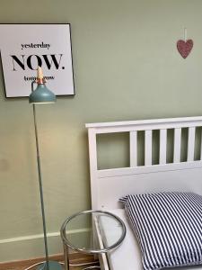 a childs room with a crib and a chair at Köln City Apartments in Cologne