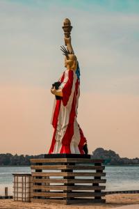 a statue of a woman dressed in an american flag at Dom Wypoczynkowy "Pod Strzechą" w Giewartowie in Giewartów
